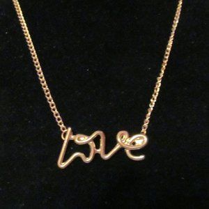 Gold tone cursive LOVE necklace